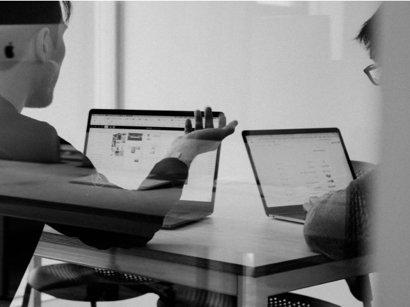 Two coworkers working on laptops